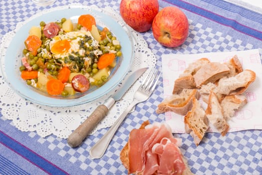 Traditional portuguese culinary meal of green peas with egg, potatoes and carrots.
