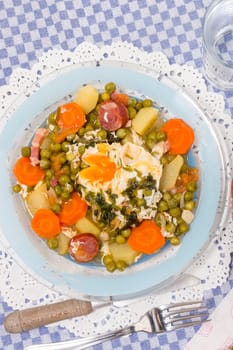 Traditional portuguese culinary meal of green peas with egg, potatoes and carrots.