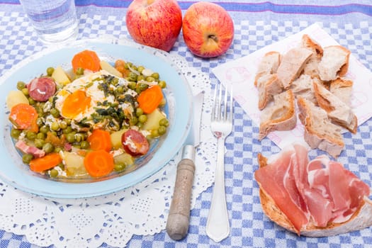 Traditional portuguese culinary meal of green peas with egg, potatoes and carrots.