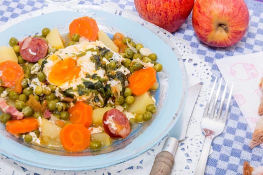 Traditional portuguese culinary meal of green peas with egg, potatoes and carrots.
