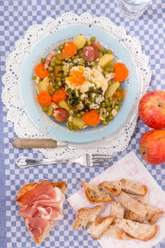 Traditional portuguese culinary meal of green peas with egg, potatoes and carrots.