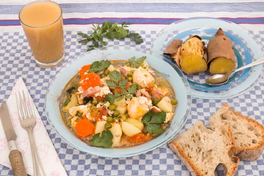 Traditional portuguese culinary meal of green peas with egg, potatoes and carrots.