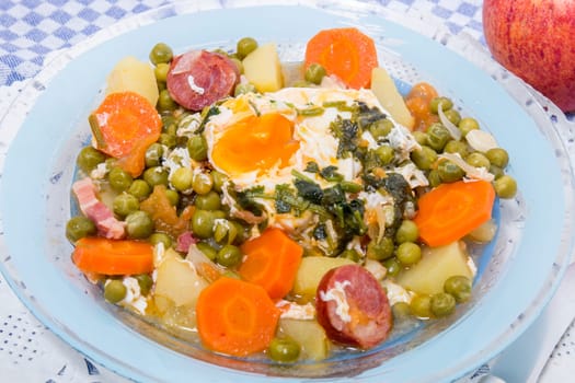 Traditional portuguese culinary meal of green peas with egg, potatoes and carrots.