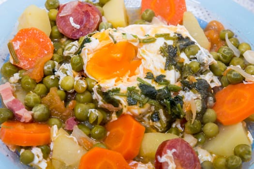 Traditional portuguese culinary meal of green peas with egg, potatoes and carrots.
