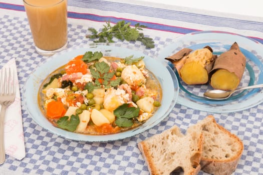 Traditional portuguese culinary meal of green peas with egg, potatoes and carrots.