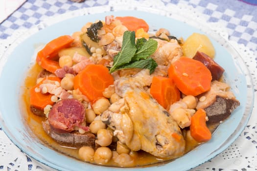 Traditional portuguese meal of Chickpeas with chicken, carrot and chorizo.