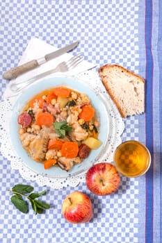 Traditional portuguese meal of Chickpeas with chicken, carrot and chorizo.