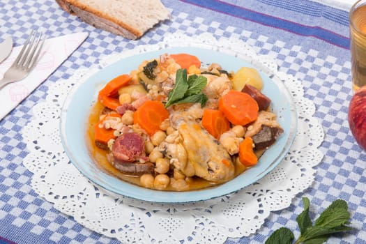 Traditional portuguese meal of Chickpeas with chicken, carrot and chorizo.