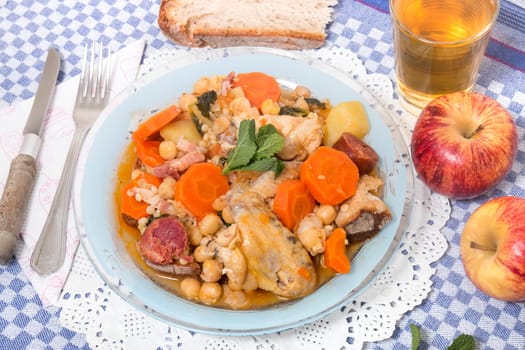 Traditional portuguese meal of Chickpeas with chicken, carrot and chorizo.