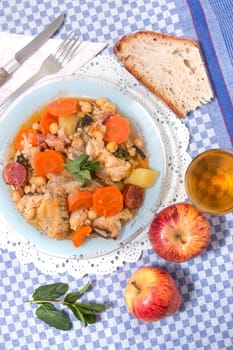 Traditional portuguese meal of Chickpeas with chicken, carrot and chorizo.