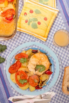 Traditional portuguese meal of fish with potatoes and tomato, made on the oven.