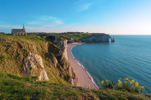 Beach, ocean and cliffs, Etretat, Normandy, France, Europe. Natural arches, white chalk cliffs over Atlantic Ocean. Sea bay, landscape Popular landmark famous destination. Aerial view of Etretat beach