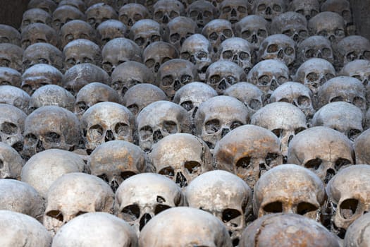 Pile of human skulls, Brno Ossuary, Czech Republic. Concept of death, evil, terror and genocide. Scary skulls, spider web, dust in catacombs Human remains in crypt Ancient burial under St James Church