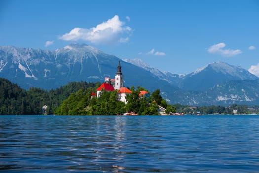 Lake Bled, Alps, Slovenia, Europe. Summer scenery. Mountain alpine lake. Island with church in Lake Bled. Beautiful landscape. Castle and mountains in background. Famous travel destination of Slovenia