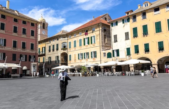 Finale Ligure (SV), ITALY - August 24, 2017: Piazza Vittorio Emanuele II in Finale Ligure ITALY. On the square there are several palaces with seventeenth-century facades and the imposing arch dedicated to Margherita Teresa of Spain. The square is also the main venue for city events.