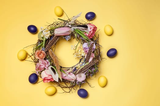 Easter card. Painted Easter eggs in nest on yellow table background. Top view of easter decoration. Happy easter concept. Trendy colors