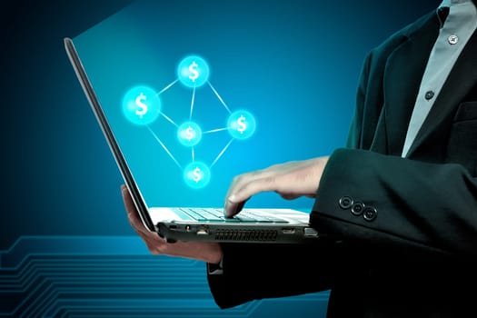 Businessman holding laptop with money network on blue background
