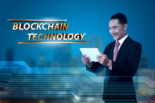 Handsome asian businessman holding digital tablet. Blockchain technology concept