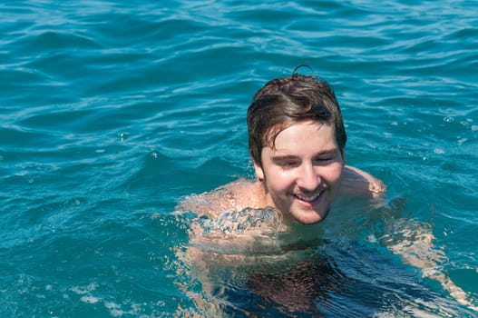 A young man take a fresh bath inside Italian sea