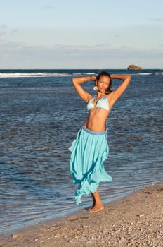 Beautiful and sexy girl posing at the beach in dominican republic dressing bikini and a turquoise skirt