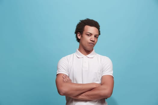 Suspicion. Doubt, mistrust, distrust concept. Doubtful man looking with disbelief expression . Young emotional man. Human emotions, facial expression concept. Studio. Isolated on trendy blue