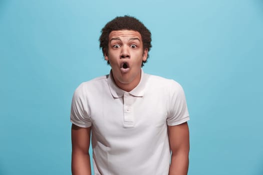 Wow. Attractive male half-length front portrait on pink studio backgroud. Young emotional surprised bearded man standing with open mouth. Human emotions, facial expression concept. Trendy colors