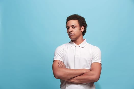 Suspicion. Doubt, mistrust, distrust concept. Doubtful man looking with disbelief expression . Young emotional man. Human emotions, facial expression concept. Studio. Isolated on trendy blue