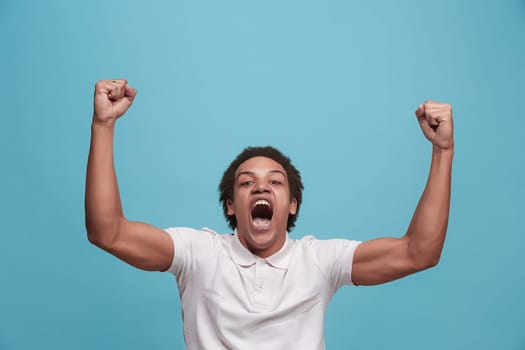 I won. Winning success happy man celebrating being a winner. Dynamic image of caucasian male model on blue studio background. Victory, delight concept. Human facial emotions concept. Trendy colors