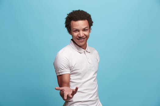 Argue, arguing concept. Beautiful male half-length portrait isolated on blue studio backgroud. Young emotional surprised man looking at camera. Human emotions, facial expression concept. Front view