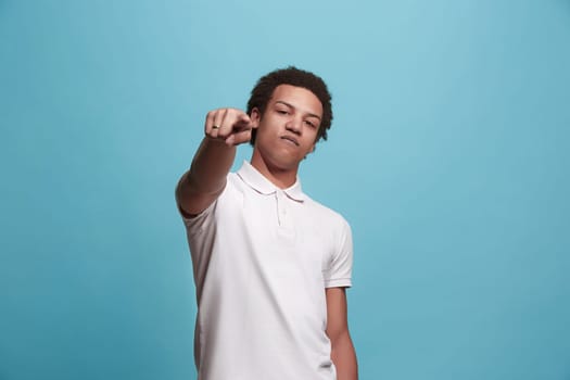 I choose you and order. Overbearing businessman point you, want you, half length closeup portrait on blue studio background. The human emotions, facial expression concept. Front view. Trendy colors