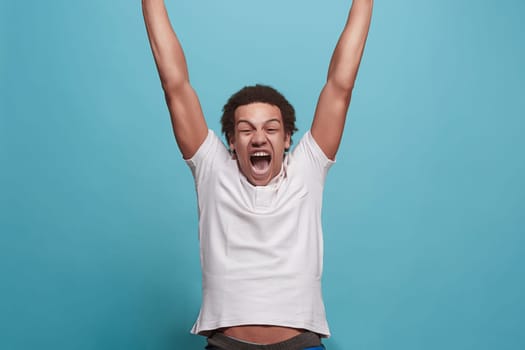 I won. Winning success happy man celebrating being a winner. Dynamic image of caucasian male model on blue studio background. Victory, delight concept. Human facial emotions concept. Trendy colors