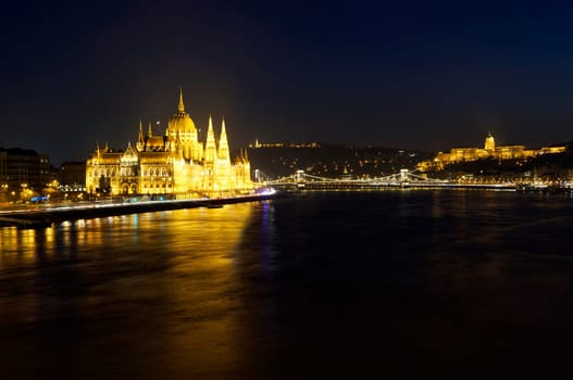 Cityscape of Budapest at night. Hungarian Parliament building, Buda castle and Chain bridge above Danube river.
