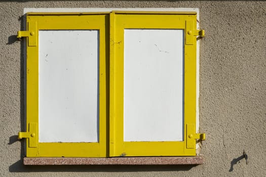 yellow shutters on the window of a house in the city center of Magdeburg