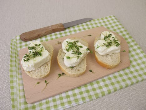 Cream cheese hearts with cress seedlings on baguette