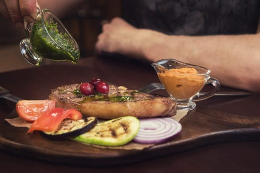 grilled beef steak with sauce and vegetables