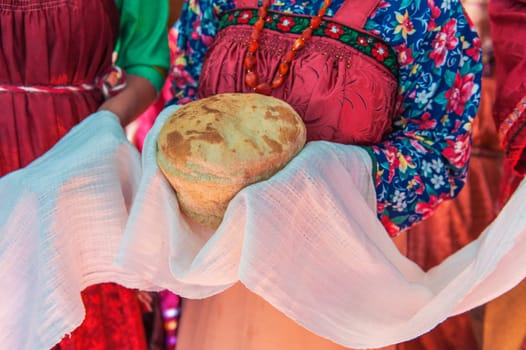 Russian old-fashioned wedding. Hands with bread, meeting with guests
