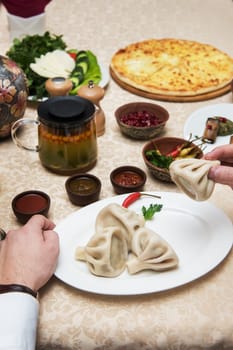 Man eating in georgian restaurant with national dishes, pov view