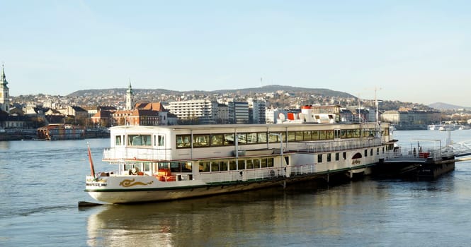 BUDAPEST, HUNGARY - NOVEMBER 22, 2017: Tourist boat moored at Danube river in Budapest, Hungary