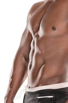 Fit young man with beautiful torso, isolated on white background. The naked torso of African American man posing at studio. The muscular body, fitness, sports, healthy lifestyle and bodybuilder concept.