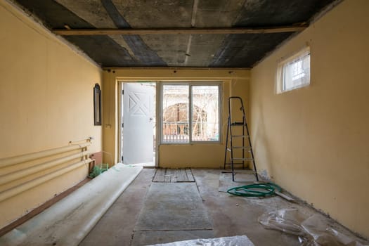 Repair in a private house, view of the entrance to the premises from the side of the street and the window