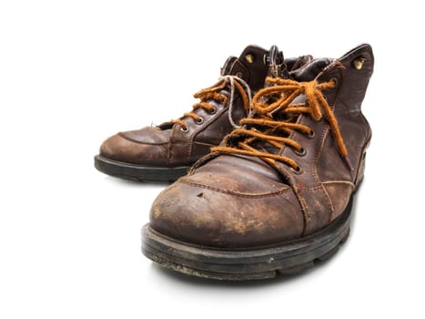 Old and worn brown leather shoes insulated on white.