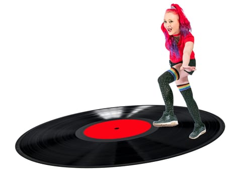 Woman with red hair and knee stockings dances laughing on a record