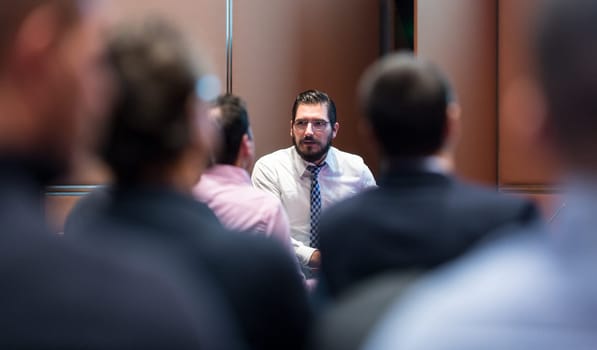 Skiled businessman presenting project to his work team at informal company business training meeting. Business people in the conference room. Business and Entrepreneurship concept.