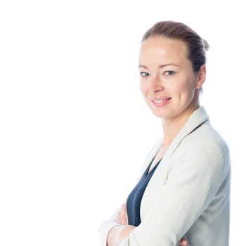 Side portrait of casualy dressed,cheerful, beautiful, smart, young businesswoman in standing with arms crossed against white background.