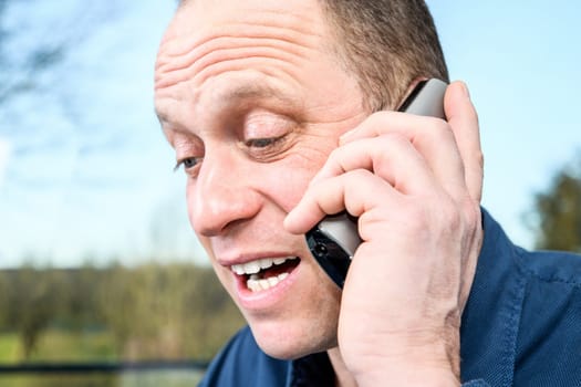man calling with green phone in front of white background