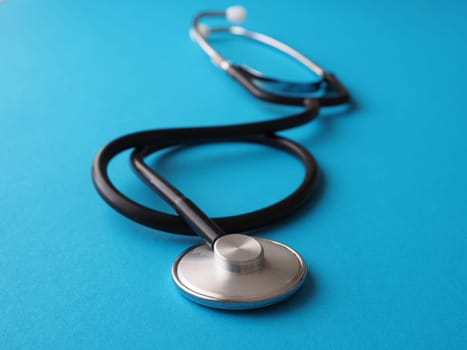 Stethoscope on a blue background, heath care or medical concept background