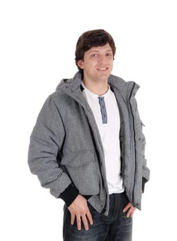 A young serious looking man standing in a gray jacket and jeans looking into.the camera, isolated for white background.
