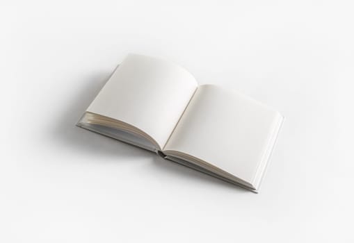Blank opened book on white paper background. Template for graphic designers portfolios.