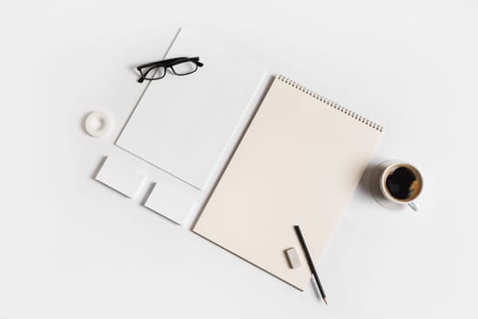 Photo of blank stationery set on white paper background. Corporate identity mock up for placing your design. Top view. Flat lay.