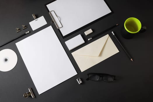 Blank stationery template for placing your design. Mockup for branding identity on black paper background.